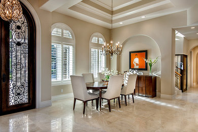 Example of a large classic travertine floor great room design in Miami with beige walls and no fireplace