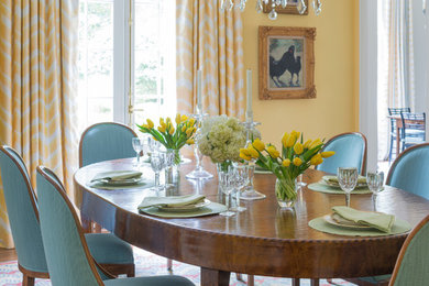 Inspiration for a large timeless dark wood floor enclosed dining room remodel in Atlanta with yellow walls