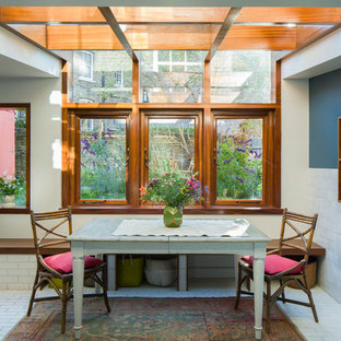 Photo of a small traditional dining room in London with beige walls, no fireplace and white floors.
