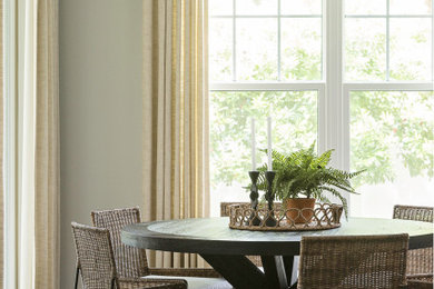 Example of a transitional dark wood floor and brown floor dining room design in Orlando with gray walls