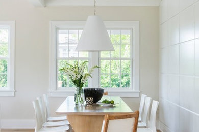 Mid-sized transitional light wood floor dining room photo in Providence with white walls and no fireplace