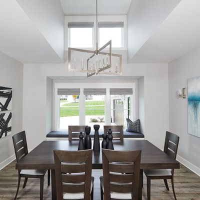 Example of a transitional medium tone wood floor and gray floor kitchen/dining room combo design in Grand Rapids with white walls