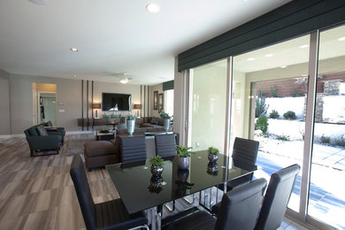 Medium sized modern kitchen/dining room in Las Vegas with grey walls, medium hardwood flooring, no fireplace and beige floors.