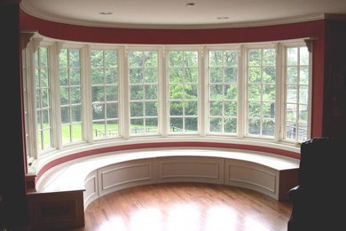 Inspiration for a small timeless medium tone wood floor dining room remodel in Cincinnati with red walls