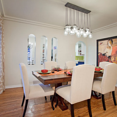 Inspiration for a mid-sized contemporary medium tone wood floor enclosed dining room remodel in Los Angeles with white walls and no fireplace