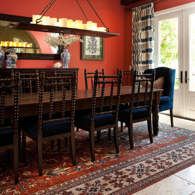 Dining room - mediterranean dining room idea in Los Angeles with red walls