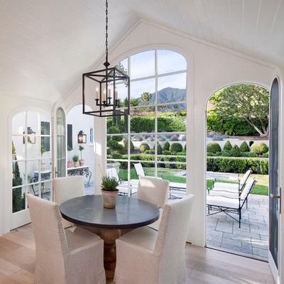 Cottage light wood floor dining room photo in Santa Barbara with white walls