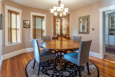 This is an example of a small traditional kitchen/dining room in Boston with beige walls, dark hardwood flooring, no fireplace and brown floors.