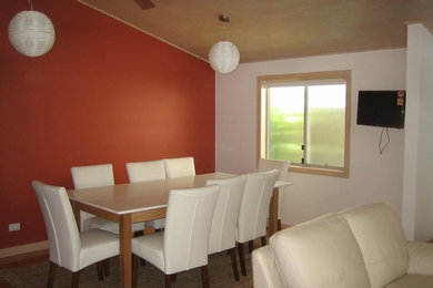 Design ideas for a medium sized coastal dining room in Gold Coast - Tweed with orange walls, medium hardwood flooring and no fireplace.