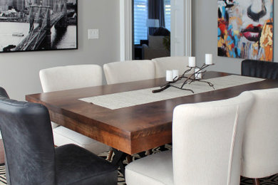 Example of a mid-sized transitional dark wood floor enclosed dining room design in Montreal with gray walls