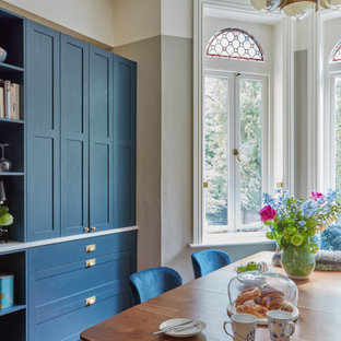 Photo of a victorian dining room in London with multi-coloured walls and medium hardwood flooring.
