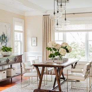 Example of a large classic medium tone wood floor dining room design in Boston with beige walls