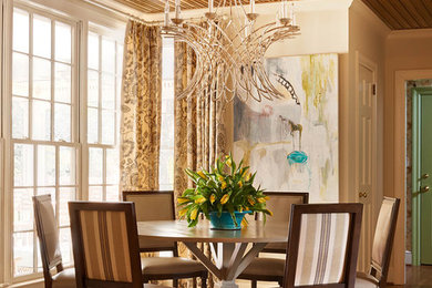 This is an example of a medium sized classic dining room in Charlotte with beige walls and medium hardwood flooring.