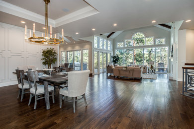 Example of a large transitional medium tone wood floor and brown floor great room design in Denver with white walls