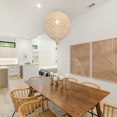 Example of a mid-sized danish light wood floor and beige floor kitchen/dining room combo design in Austin with white walls and no fireplace