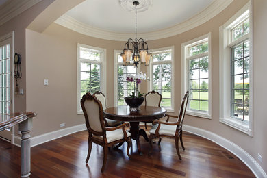 Traditional dining room in New York with beige walls and medium hardwood flooring.