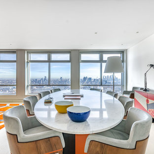 Medium sized contemporary open plan dining room in London with white walls, light hardwood flooring and no fireplace.