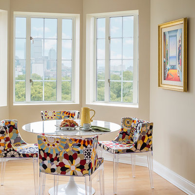 Example of a mid-sized eclectic light wood floor and brown floor kitchen/dining room combo design in Boston with beige walls and no fireplace