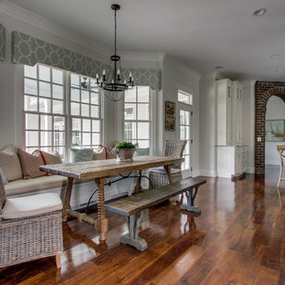 Example of a large classic medium tone wood floor dining room design in Nashville with gray walls
