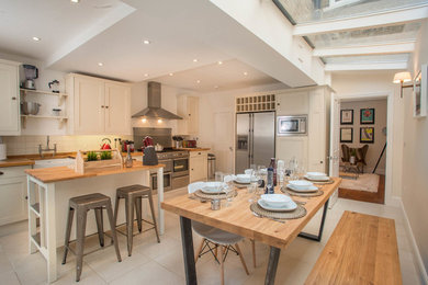 Inspiration for a farmhouse kitchen/dining room in London with beige walls.