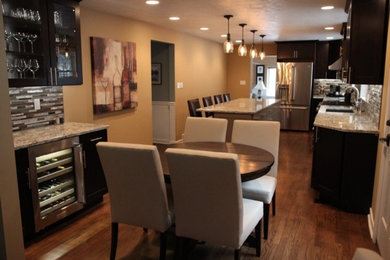 Example of a mid-sized trendy medium tone wood floor and brown floor kitchen/dining room combo design in Other with multicolored walls and no fireplace