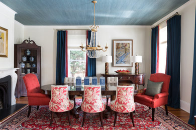 Inspiration for a classic enclosed dining room in DC Metro with beige walls, medium hardwood flooring, a standard fireplace, brown floors and feature lighting.