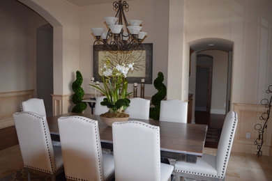 Enclosed dining room - large transitional travertine floor and beige floor enclosed dining room idea in San Diego with beige walls and no fireplace
