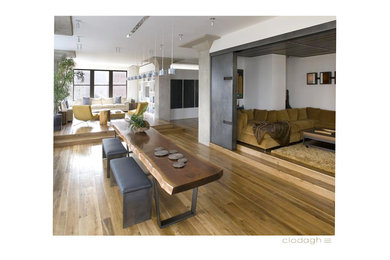 Large trendy medium tone wood floor and beige floor great room photo in New York with white walls and no fireplace