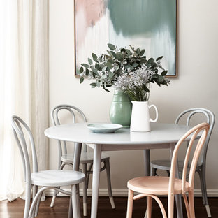 Transitional dining room in Melbourne with beige walls, dark hardwood floors and brown floor.