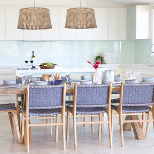 Photo of a mid-sized beach style open plan dining in Sydney with travertine floors and beige floor.