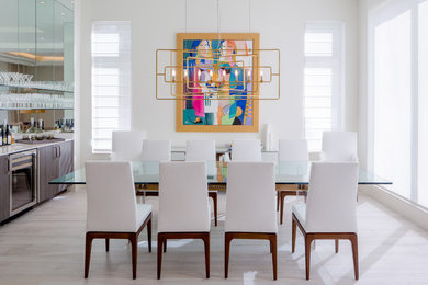 Enclosed dining room - contemporary light wood floor enclosed dining room idea in Miami with white walls and no fireplace