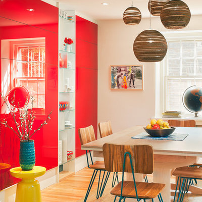 Example of a trendy medium tone wood floor dining room design in Philadelphia with white walls