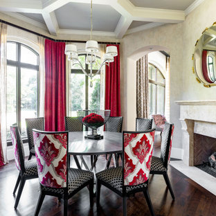 Esempio di una sala da pranzo chic con pareti beige, parquet scuro, camino classico, pavimento marrone e soffitto a cassettoni