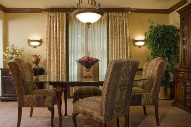 This is an example of a large traditional kitchen/dining room in St Louis with beige walls and carpet.