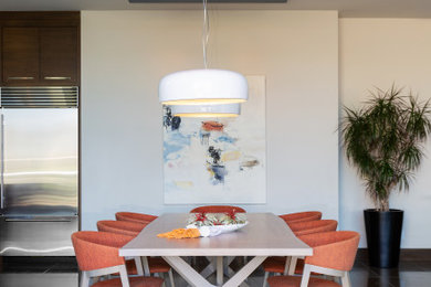 Photo of a contemporary dining room in San Diego with white walls, no fireplace and grey floors.