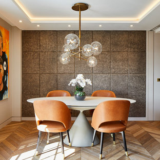 Inspiration for a contemporary dining room in Kent with grey walls, medium hardwood flooring and brown floors.