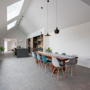 Contemporary kitchen/dining room in West Midlands with white walls and grey floors.
