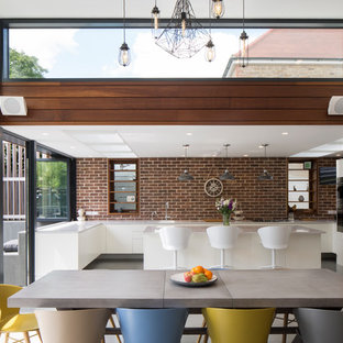 Medium sized contemporary kitchen/dining room in Sussex with white walls.