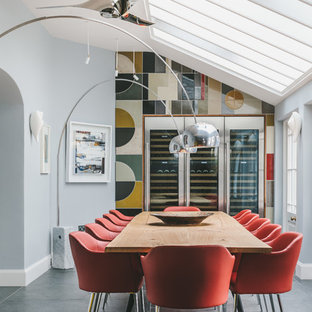 Photo of a medium sized classic enclosed dining room in Other with multi-coloured walls, no fireplace and grey floors.
