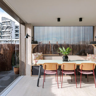 Design ideas for a contemporary kitchen/dining room in London with light hardwood flooring and beige floors.
