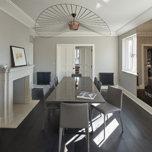 This is an example of a large contemporary dining room in Other with dark hardwood flooring, black floors and grey walls.