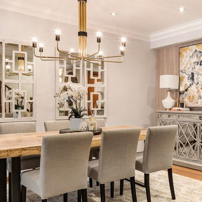 Enclosed dining room - transitional medium tone wood floor and brown floor enclosed dining room idea in Singapore with gray walls