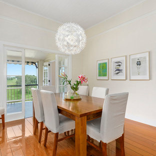 Inspiration for a country separate dining room in Brisbane with beige walls, medium hardwood floors and brown floor.