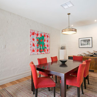 Design ideas for a mid-sized transitional separate dining room in Sydney with white walls, medium hardwood floors, brown floor and no fireplace.