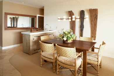 Example of a small island style travertine floor dining room design in Hawaii