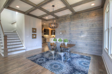 Great room - mid-sized industrial dark wood floor great room idea in Nashville with white walls and no fireplace