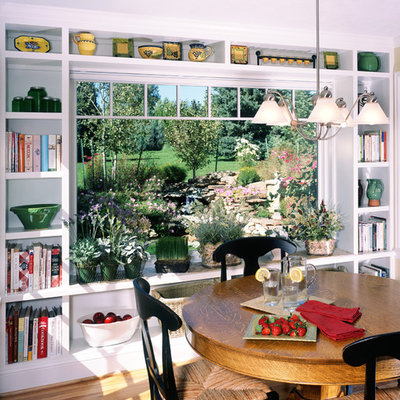 Example of a classic medium tone wood floor dining room design in Denver with white walls