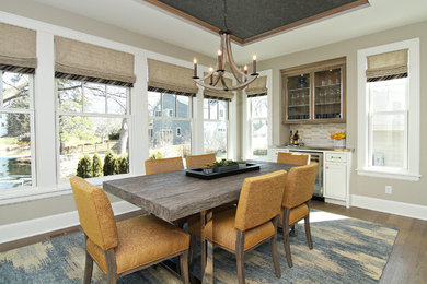 Photo of a large traditional enclosed dining room in Minneapolis with beige walls, dark hardwood flooring and no fireplace.