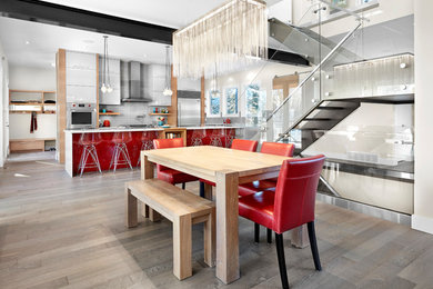 Inspiration pour une salle à manger ouverte sur la cuisine design avec un sol en bois brun.
