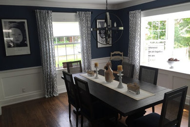Example of a small transitional dark wood floor enclosed dining room design in New York with blue walls and no fireplace